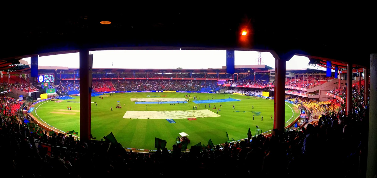 Archival floodlit Chinnaswamy cricket match photograph, not the October 2026 fixture
